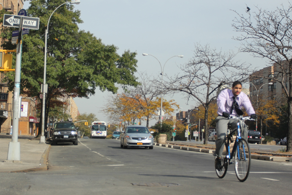 A cyclist rides on the Grand Concourse ahead of traffic