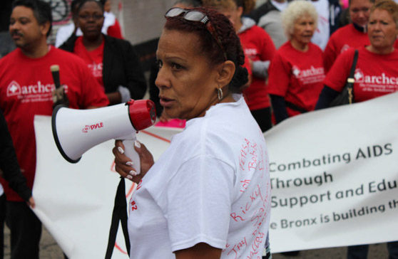 Millie Colon, chairperson of the Community Board 2 AIDS WALK, rallying the marchers before the walk begins in Hunts Point (BENJAMIN BERGMANN/The Bronx Ink)