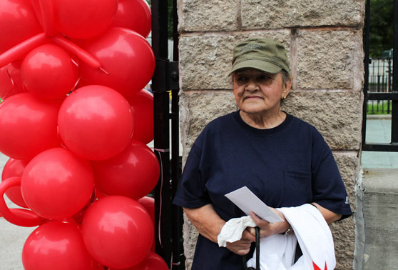 Carmen Rodriguez stands outside the Hunts Point Recreational Center after revealing to the group of marchers that her husband passed away from AIDS just last week