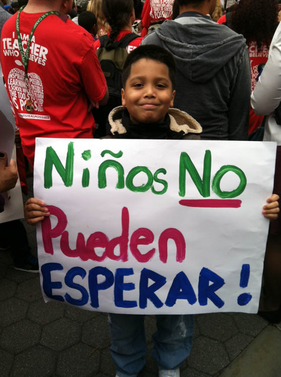 Omar Soto, 7, from Success Academy Bronx 1 holds a  Don't Stop Possible sign in Spanish. Jamari Hysaw/BRONX INK
