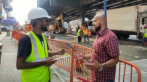 Michael Beltzer speaks with a local worker.