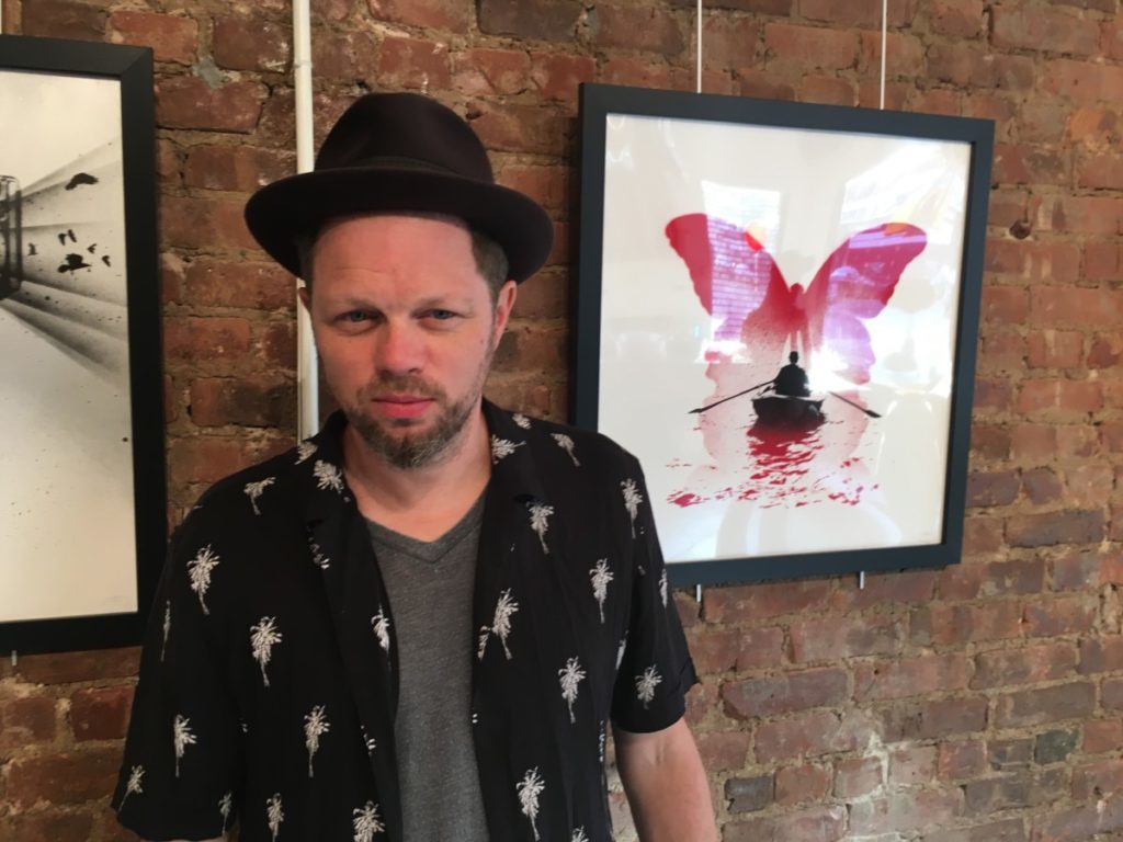 British Artist Nick Walker poses with his favorite painting of the show.