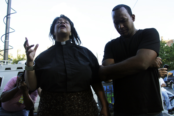 9 September, 2012- Bronx - Reverend Que English (left) holds prayer for Reynaldo Cuevas, the young father from the Dominican Republic accidentally shot by police during a robbery scuffle on Friday morning. (The Bronx Ink/Jika González)